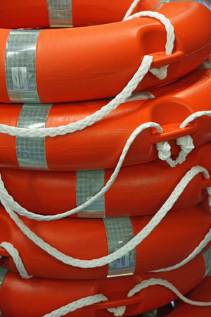 piles of Orange life preserver for help to people in danger of drowningの写真素材