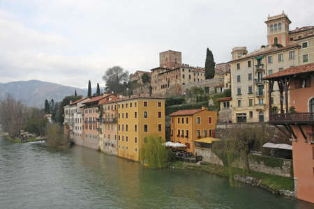 houses and residences bassano city overlooking the brenta River on a cloudy dayのeditorial素材