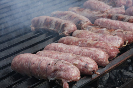 sausage meat and steak in a giant barbecue in the gardenの写真素材