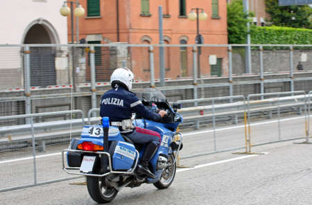 Italian State police motorcycle runs fast on the road to an emergencyの写真素材