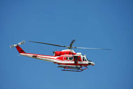 patrol helicopter of firefighters in blue sky over a fire 8の写真素材