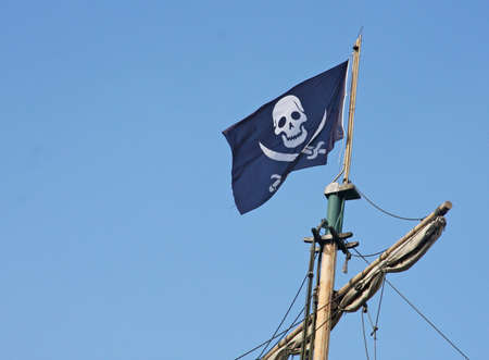 black pirate flag that flies above the Corsair shipの写真素材