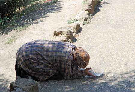 poor old Gypsy woman begging for pedestrians on the streetのeditorial素材