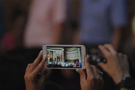 elegant woman's hand holding the phone while making a video recordingの写真素材