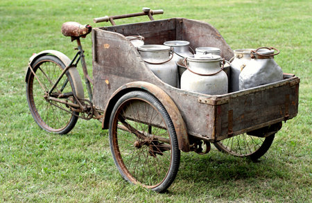 rusty old bikes of ancient milkman with aluminium drum