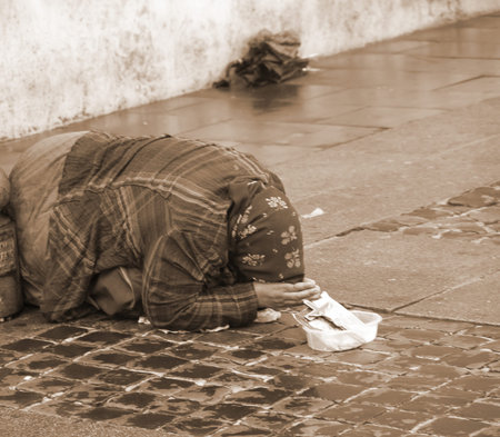 ancient Gypsy with lurid clothes while begging on the street