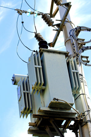 electricity transformer mounted on a tall pole outdoors