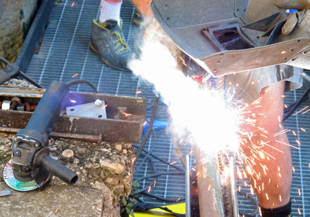expert welder with welding mask with a blowlamp