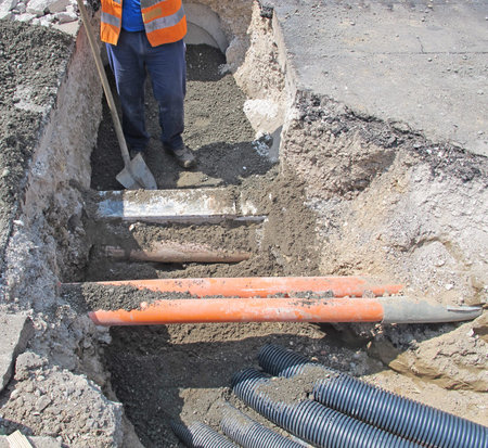 laying of optical fiber and electric cables in a roadworks and a worker 2