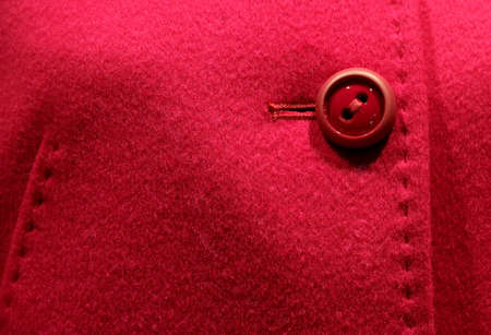 stylish coat with red button and sewn by hand stitchingの写真素材