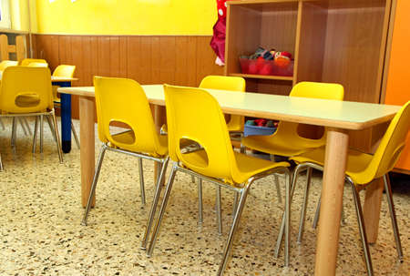 particular of a classroom in a kindergarten with little yellow chairs for the childrenのeditorial素材