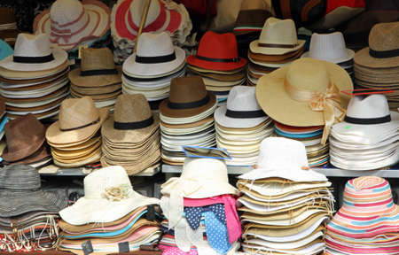 market stall with many hats in straw hats for sale in various sizesの写真素材