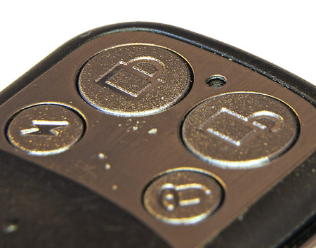 clsoe up of a button on the remote control to close and open the gates