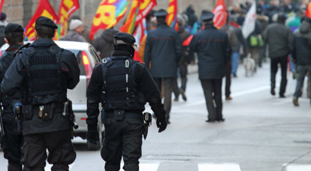 armed police and riot gear escorted the procession of protesters into the narrow streets of the city...