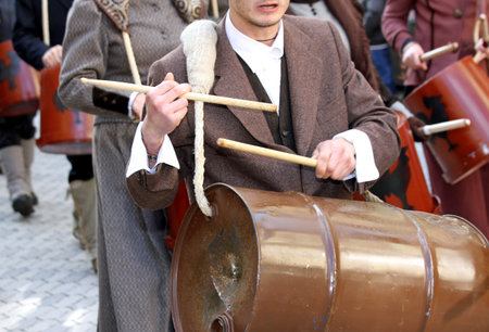 young man with a drum during the parade in a city street