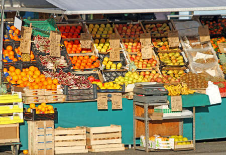 lots of seasonal fruits and vegetables for sale in the fruit and vegetable stall at fruit and vegetable marketのeditorial素材