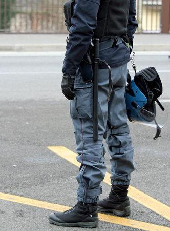 Police in riot gear with helmets and truncheons
