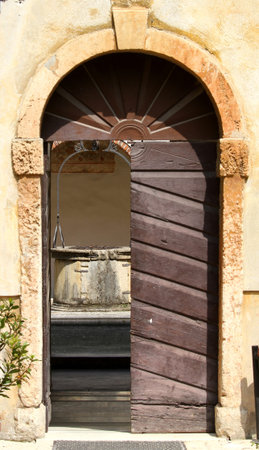 old wooden door of the convent of the Friars and the pit in the cloisterの写真素材