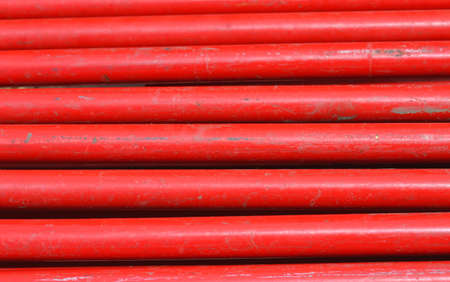 uniform background of red iron horizontal tubesの写真素材