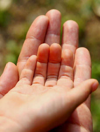 the child's hand in hand protector of his fatherの写真素材