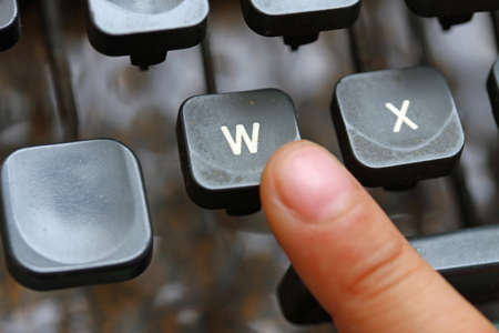 child press the W key symbol of the victory of an ancient mechanical typewriterの写真素材