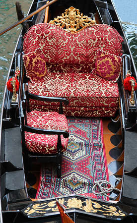 luxurious interior of a gondola in Venice with precious carpets and upholstered chairsの写真素材