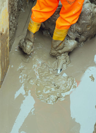 Yellow worker boots in brown mud during the flood 6