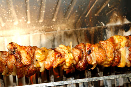 hot skewers of meat cooked on a spit in the fireplace 3の写真素材