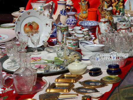 ancient ceramic cups with the teapot and other vintage objects in the antique shopの写真素材