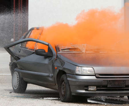 Dense Orange smoke escapes from the car destroyedの写真素材