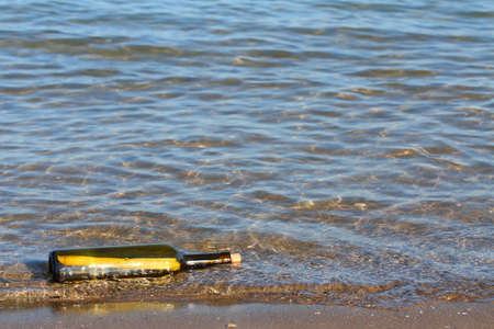 secret message in glass bottle in the oceanの写真素材