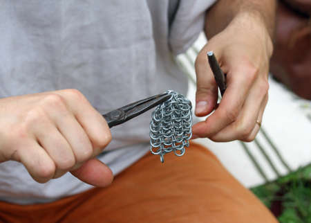 skilled craft produces a medieval chainmail with clampの写真素材