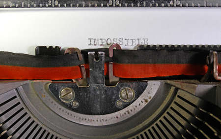 IMPOSSIBLE written with an old mechanical typewriterの写真素材