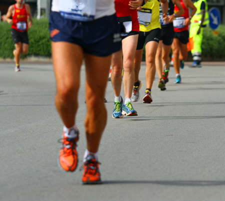muscular legs of athletes engaged in long international marathonの写真素材