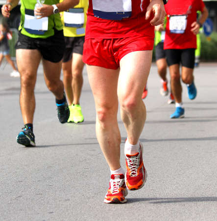 Group of athletes of various nationalities run fast Marathon in the streetsの写真素材