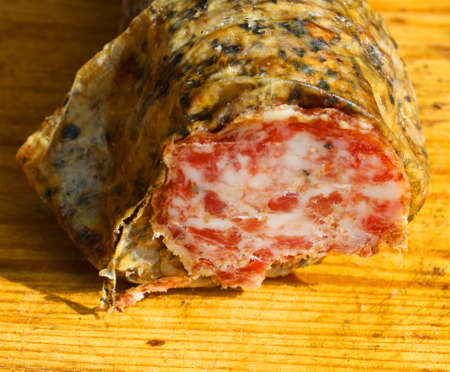 wild boar salami on a wooden cutting board in Tuscanyの写真素材