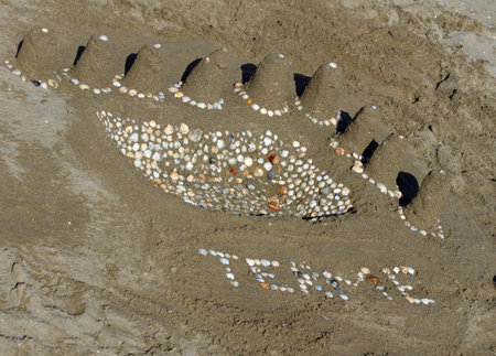 sand sculpture: ancient baths made with shells and TERME written
