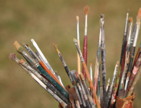 set of brushes used by a painter in painting workshopの写真素材