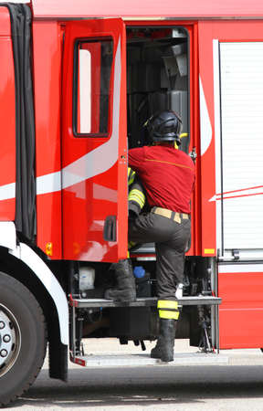 fireman working near the fire truck when handling an emergencyの写真素材