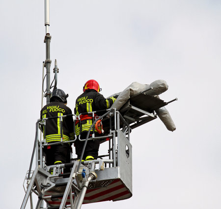 two firefighters during a rescue exercise a hurt with a dummyの写真素材