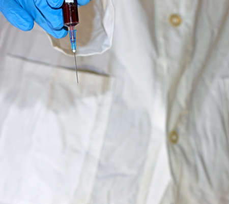 syringe with human blood taken to carry out an analysis in chemical laboratoryの写真素材