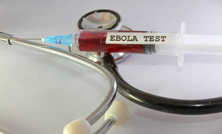 syringe testing the ebola virus and the doctor's stethoscope in doctor's Officeの写真素材