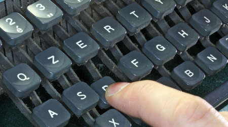 keyboard of the old typewriter and a fingerの写真素材