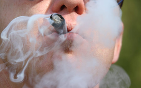Young smoker with big cigar in his mouth