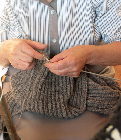 elderly woman knit with knitting needlesの写真素材