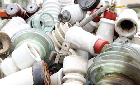 old ceramic insulators in an old dump obsolete material and hazardous wasteの写真素材