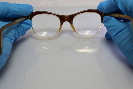 hand with blue glove and glassの写真素材