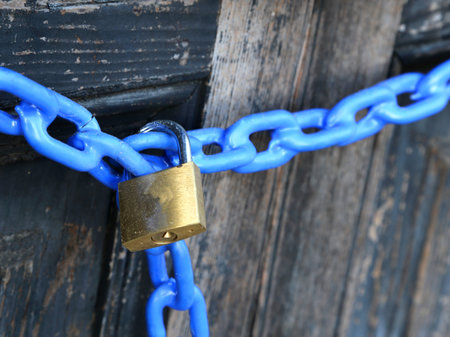 padlock with a blue chain and  the door closed
