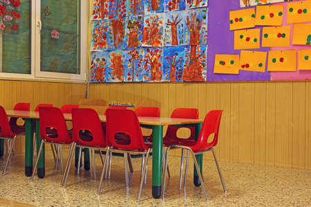 red chairs and benches of a school for young childrenの写真素材