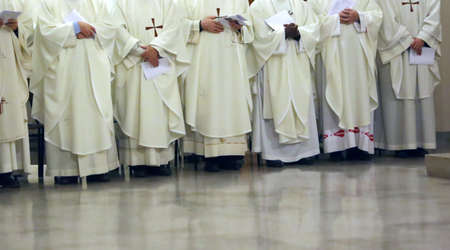 many priest with the white cassock during the religious celebrationの写真素材